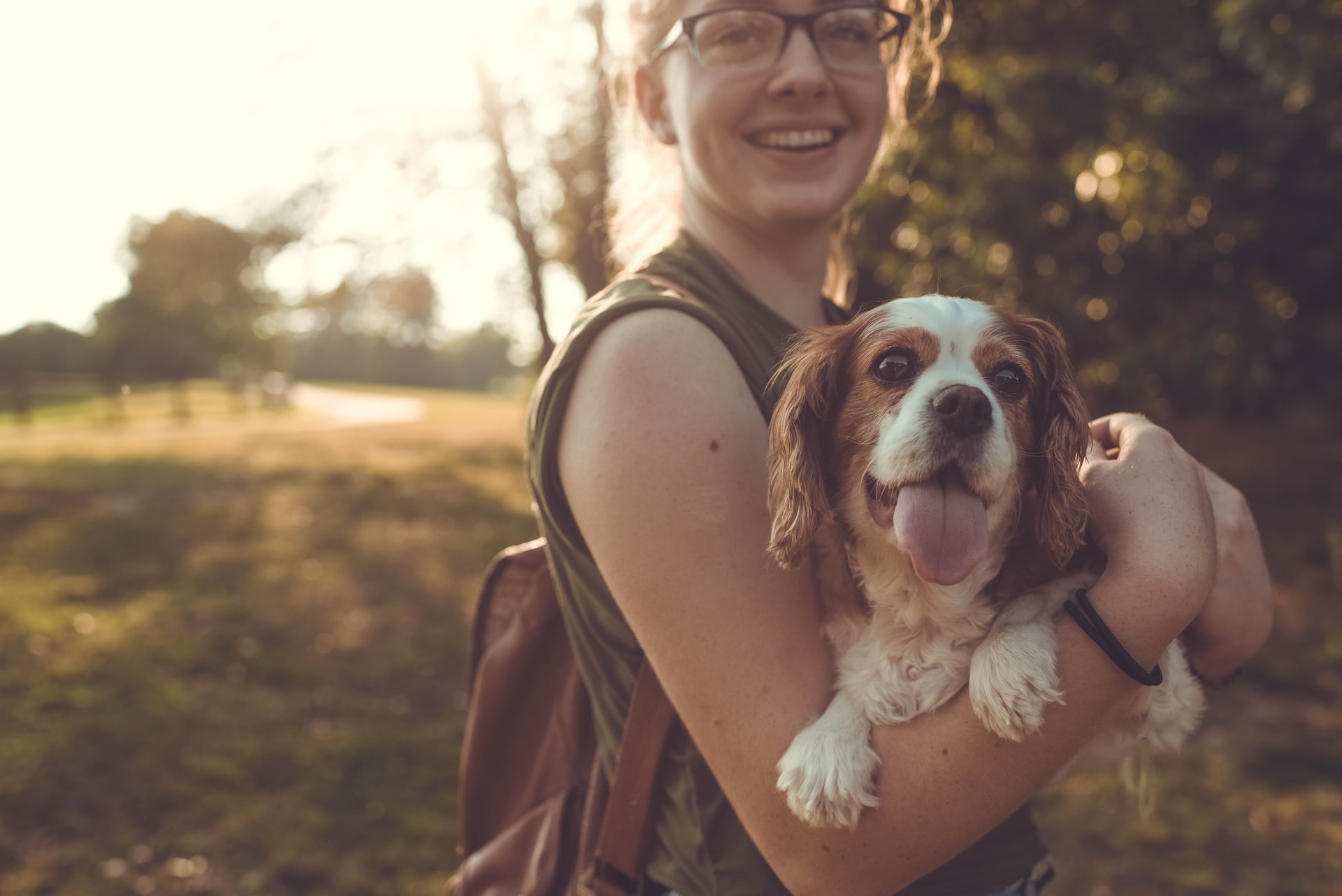 Young woman in park with dog | Photo by Sam Manns on Unsplash